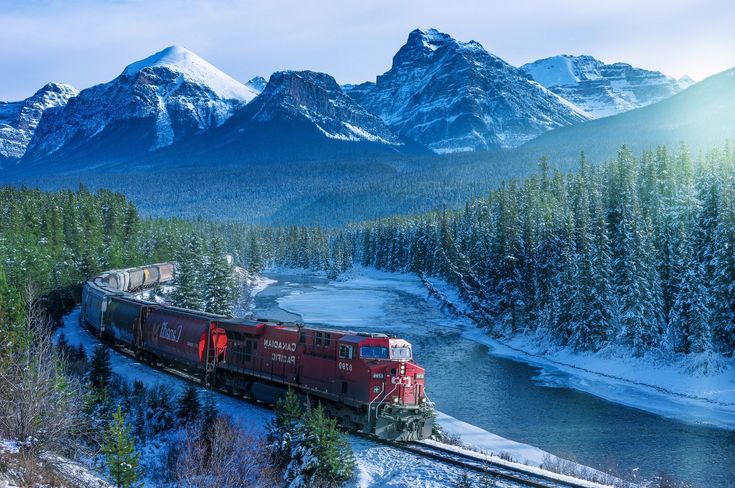 A scenic railway winding through the North American Rocky Mountains